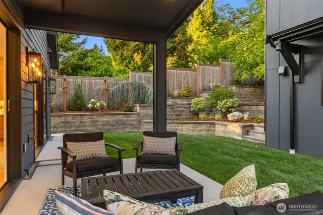 a view of a patio with couple of chairs and a table