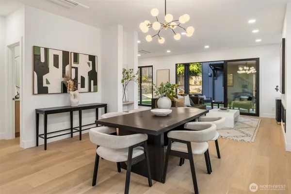 a view of a dining room with furniture and chandelier