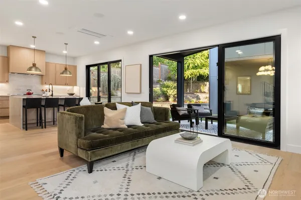 a living room with furniture and large windows
