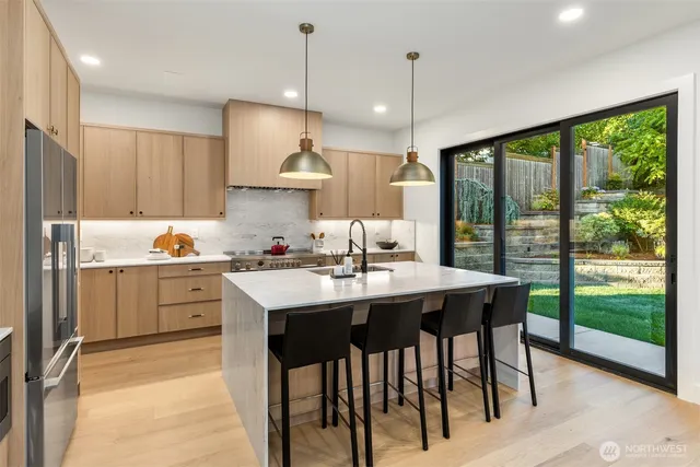 a kitchen with a table chairs sink and cabinets