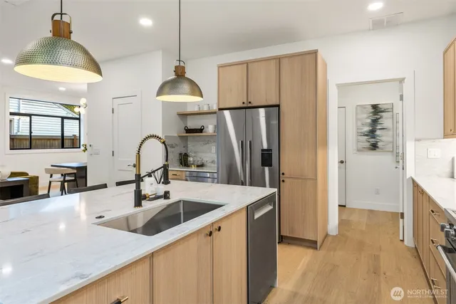 a kitchen with stainless steel appliances a sink and a refrigerator