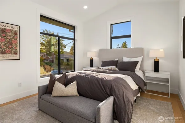 a bedroom with a bed and a large window