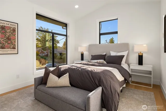 a bedroom with a bed and a large window