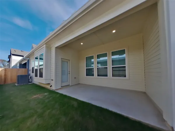 a view of an house with backyard and porch