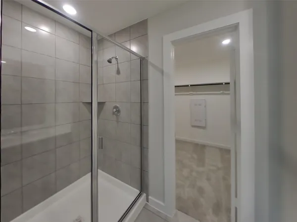 a bathroom with a shower and a mirror