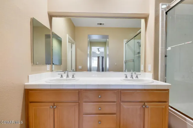 a bathroom with a double vanity sink and a mirror