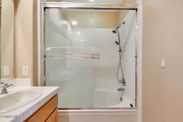a bathroom with a shower and a sink