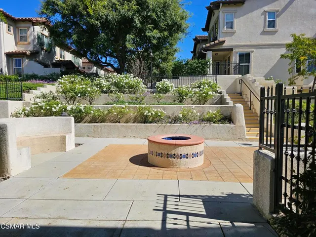 a view of a patio with table and chairs potted plants