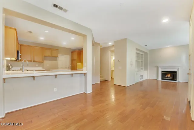 a view of a kitchen with a sink and a large window