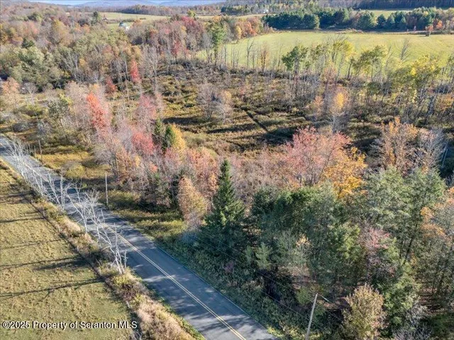 an aerial view of a house with a swimming pool