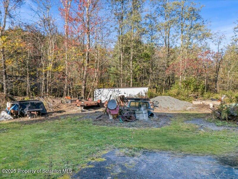Marshbrook Road Factoryville, PA 18419 - Photo 24 of 34 a view of a backyard with table and chairs and a large tree
