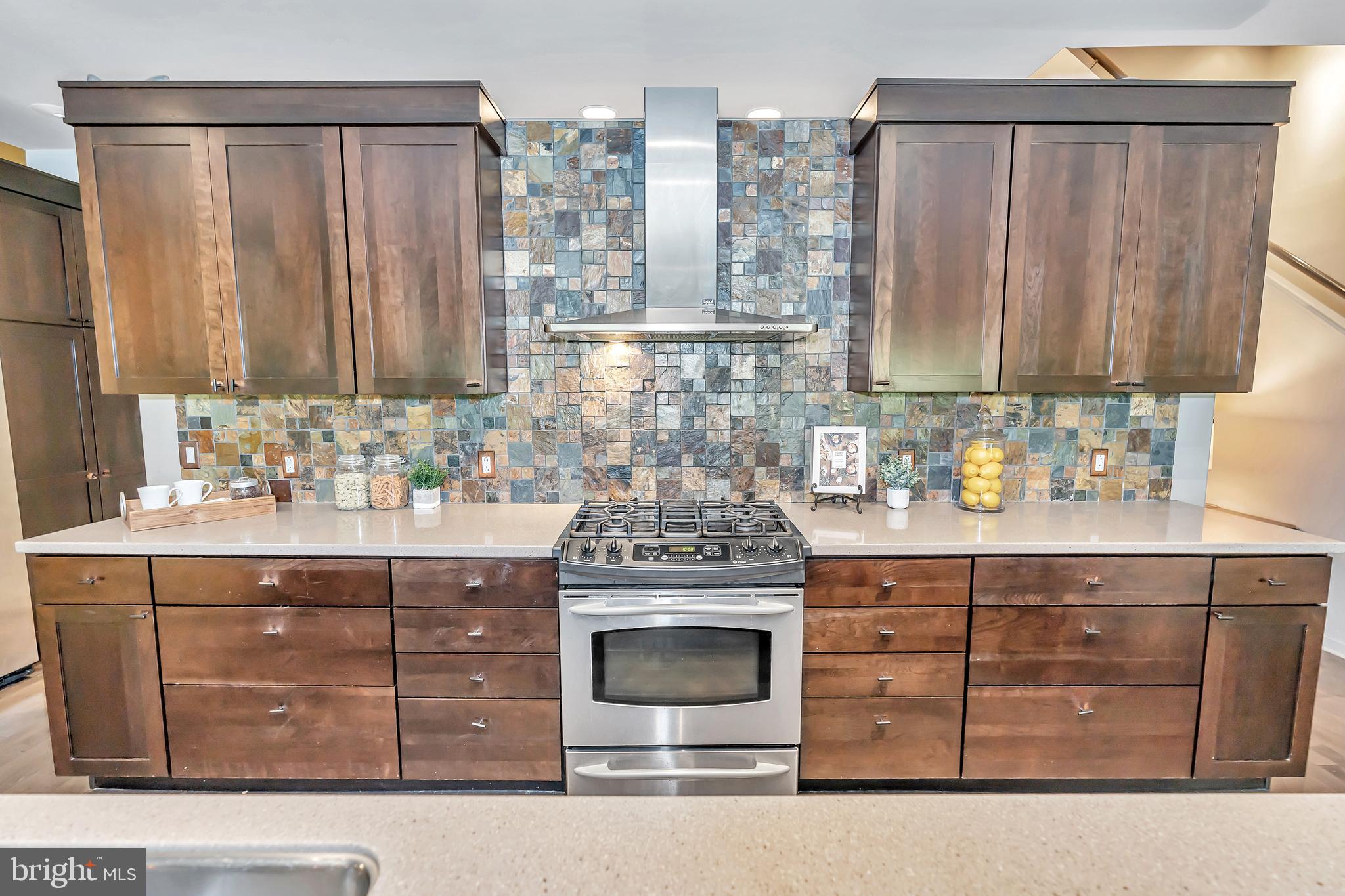 118 Bancroft Mills Road Wilmington, DE 19806 - Photo 12 of 40 a kitchen with stainless steel appliances granite countertop a stove a sink and a microwave