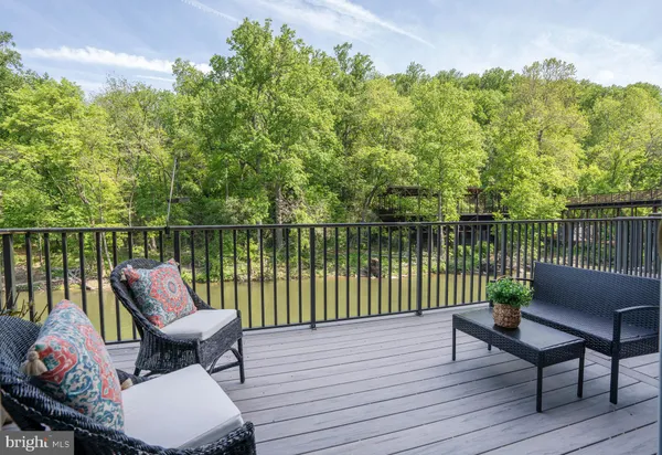 a balcony with wooden floor table and chairs