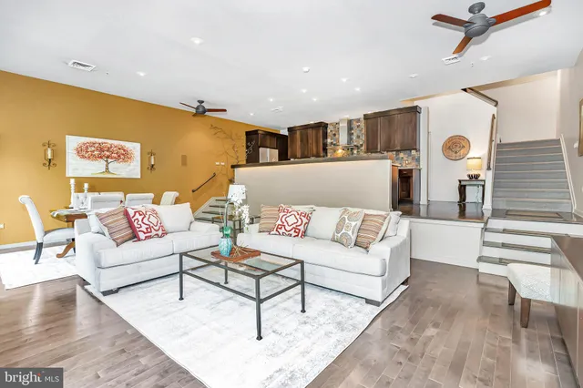 a living room with furniture and wooden floor