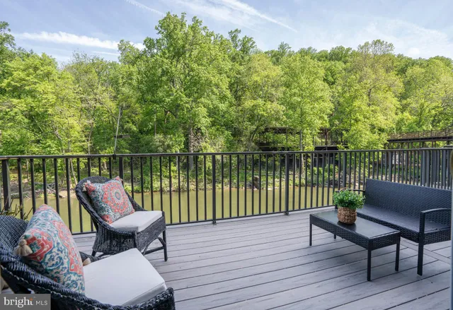 a balcony with wooden floor table and chairs