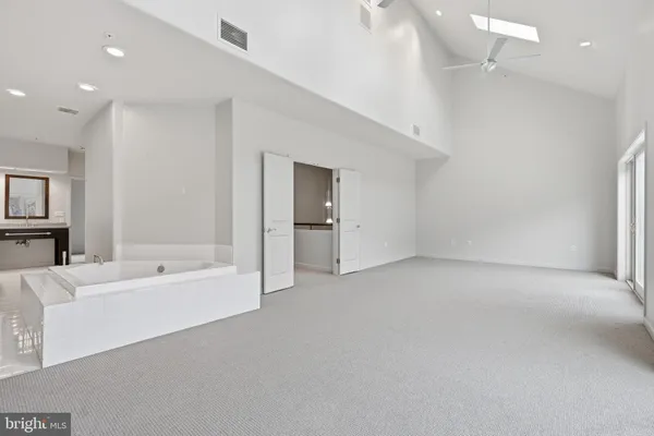 a spacious bedroom with a bed and a couch