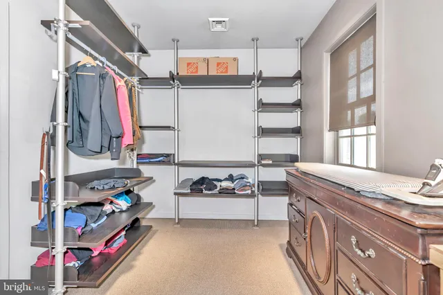 a bedroom with a bed and painting on the wall