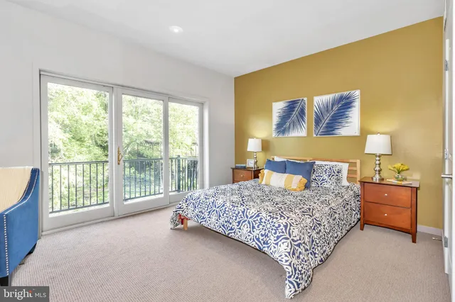 a bedroom with a bed and a chair in it