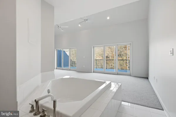 a large bathroom with a granite countertop sink mirror and a bathtub