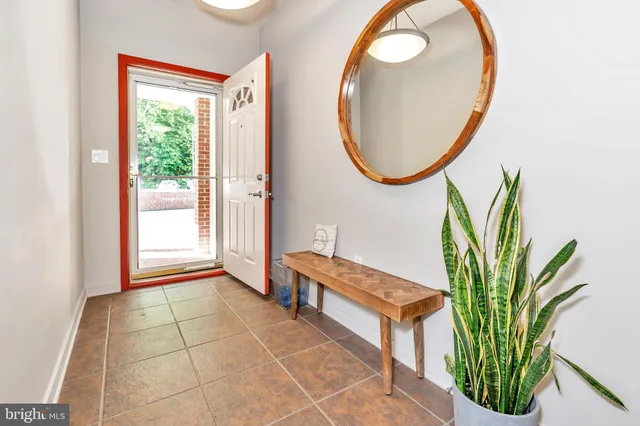 a bathroom with a mirror and a potted plant