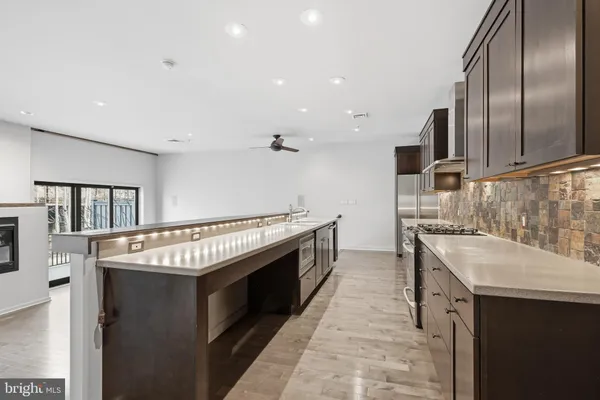 a kitchen with stainless steel appliances granite countertop a sink and a stove