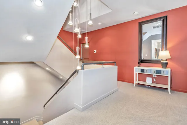 a room with stairs and a chandelier