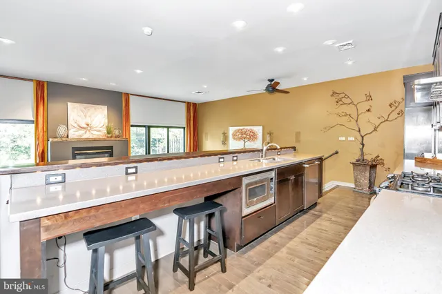 a large kitchen with stainless steel appliances granite countertop a sink and cabinets
