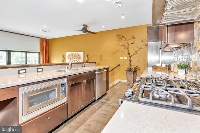 a large white kitchen with a large window