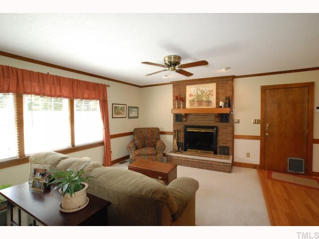7516 Deer Track Drive Raleigh, NC 27613 - Photo 2 of 11 Living Room with Ceiling Fan, Accent Lighting, Plantation Blinds & Wood Burning Masonry Fireplace.