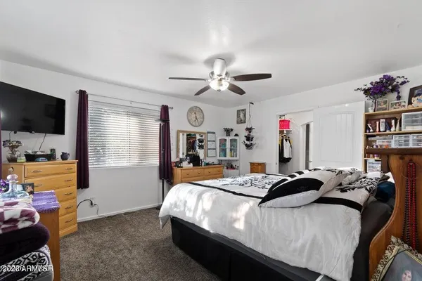 a bed sitting in a bedroom next to a window