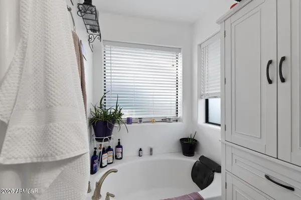 a white toilet sitting next to a bathroom sink