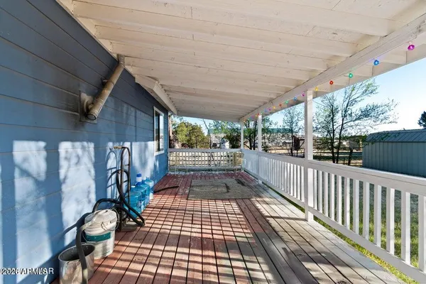 a view of a porch with wooden floor