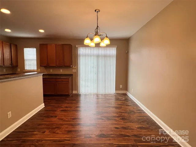 a view of kitchen with granite countertop cabinets and wooden floor