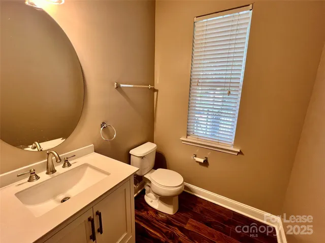 a bathroom with a sink a toilet and mirror