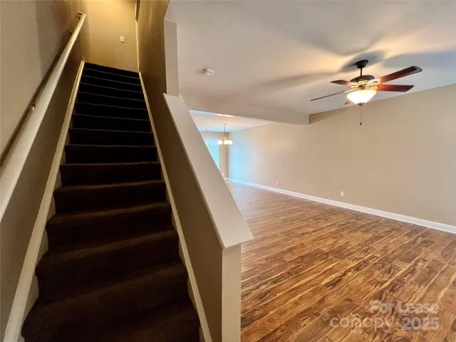 wooden floor in an empty room with stairs