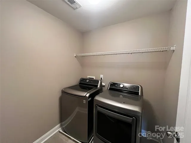 a view of storage and utility room with washer and dryer