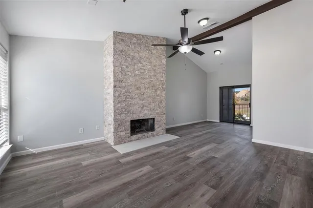 wooden floor in an empty room with a fireplace