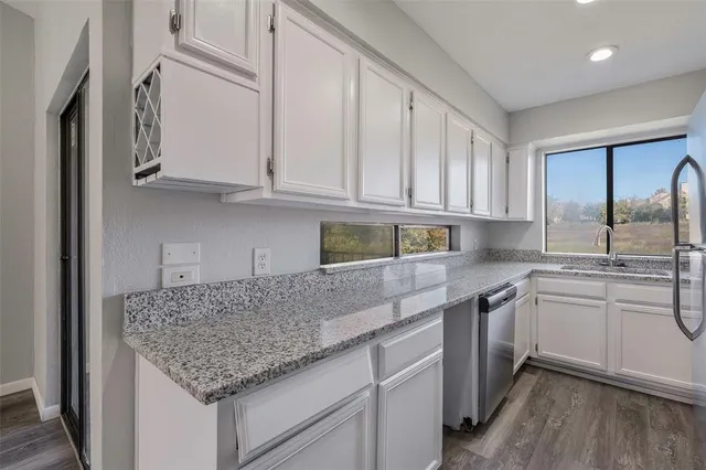a kitchen with stainless steel appliances granite countertop a sink and cabinets