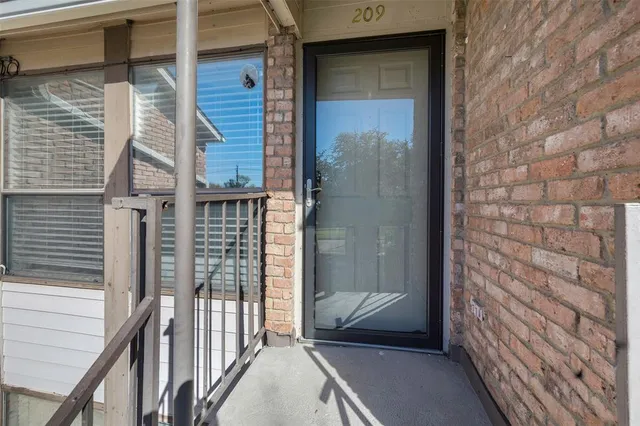 a view of a door and wooden floor
