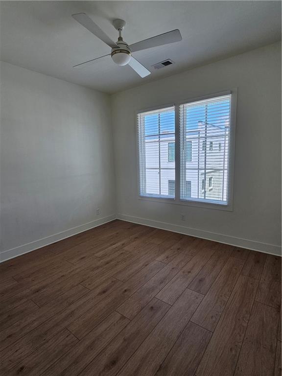 1294 Longreen Terrace Northwest, Unit 2 Atlanta, GA 30318 - Photo 24 of 25 a view of an empty room with wooden floor and a window