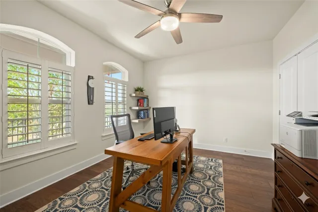 a view of a workspace with furniture and a window