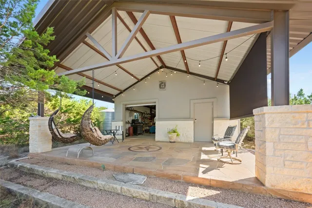 a view of a patio with table and chairs potted plants