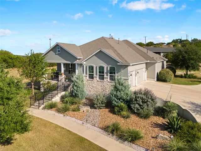 a front view of a house with a garden