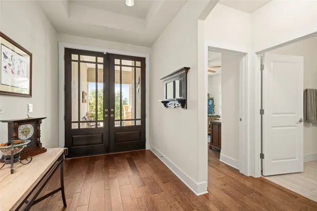 a view of a workspace with wooden floor and furniture
