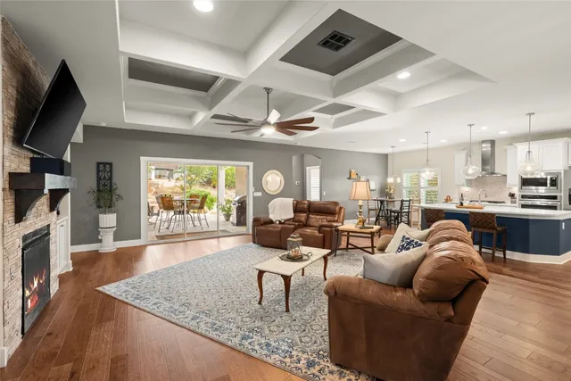 a living room with fireplace furniture and a flat screen tv