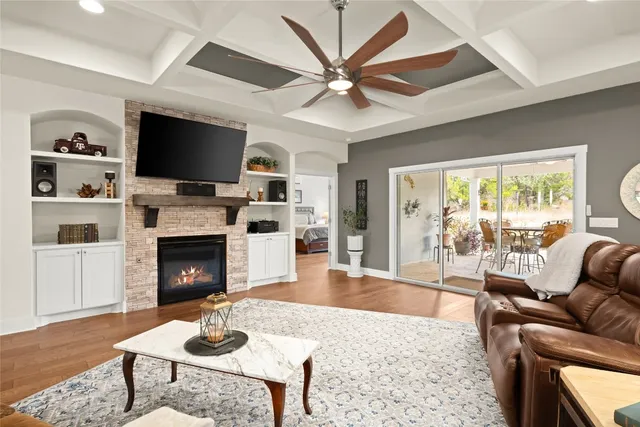 a living room with furniture a fireplace and a flat screen tv