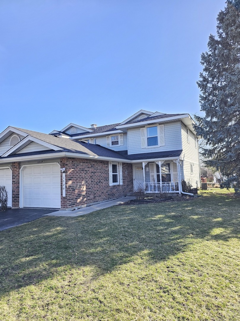 1529 Lighthouse Drive Naperville, IL 60565 - Photo 2 of 21 a front view of a house with a yard