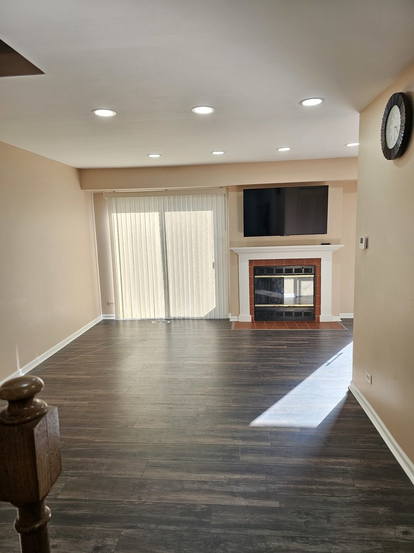 1529 Lighthouse Drive Naperville, IL 60565 - Photo 4 of 21 a view of an empty room with a fireplace and a window