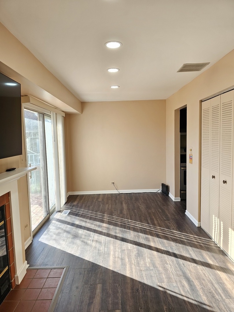 1529 Lighthouse Drive Naperville, IL 60565 - Photo 6 of 21 a view of a livingroom with wooden floor and a fireplace