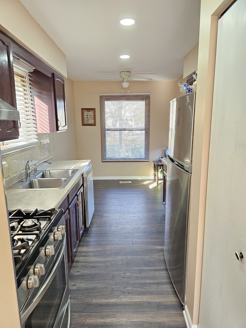 1529 Lighthouse Drive Naperville, IL 60565 - Photo 7 of 21 a view of a hallway with wooden floor and staircase